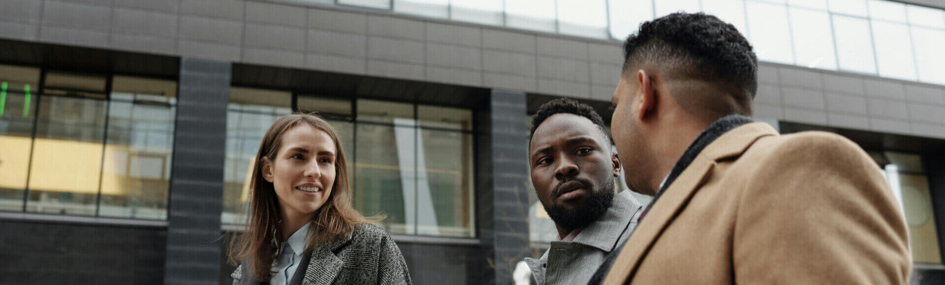 Group of professionals discussing ideas outdoors with coffee, reflecting teamwork and collaboration in a thriving business with genuine professionals.