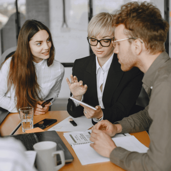 Team of professionals collaborating on financial strategies, showcasing expert guidance for corporate financial success in a modern office setting.