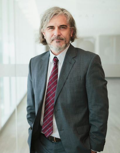 Confident businessman in a suit standing in a modern office, representing the experienced and professional UreSuccess team focused on driving business growth.