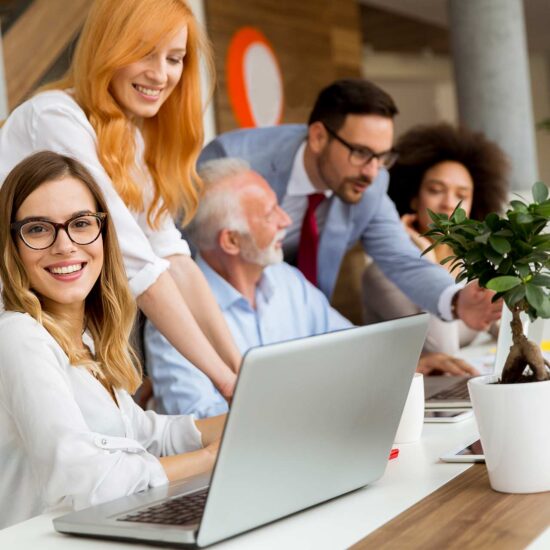 Professional business team collaborating in a modern office, representing a company with over 30 years of experience dedicated to providing the best services, supporting clients, and driving business growth through expertise and teamwork